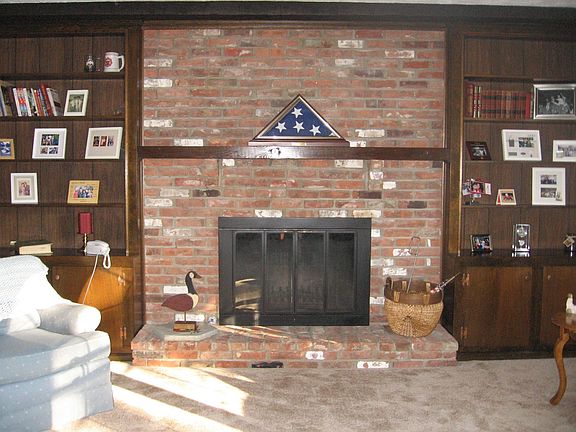 Beautiful Wood Burning and Gas Fireplace with built in book shelves