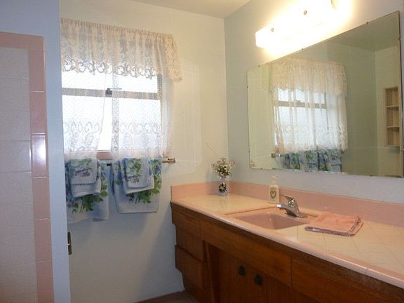 Bathroom offers tile sink and tub backsplash.