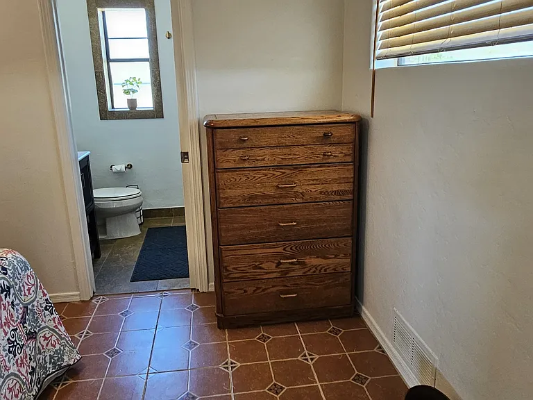 Closet and dresser with flip-top mirror.