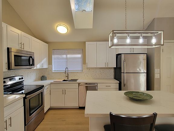 Newly remodeled kitchen, with quartz counters, stainless steel appliances, and updated cabinets