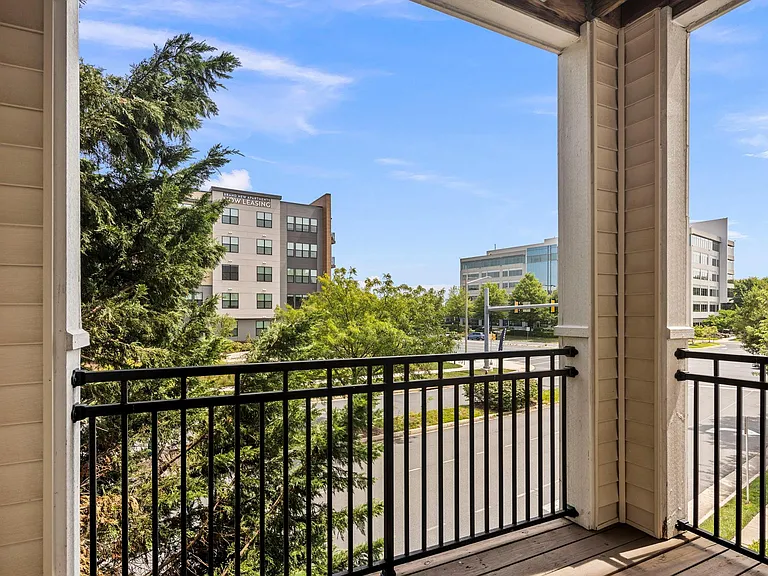 Balcony surrounded by arborvitae tree and nearby park. Many nearby walk paths.