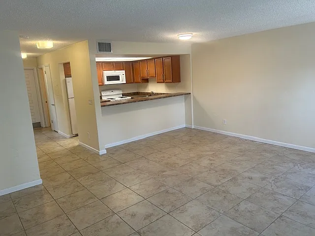 Great Room looking back at kitchen, viewing from rear porch door.