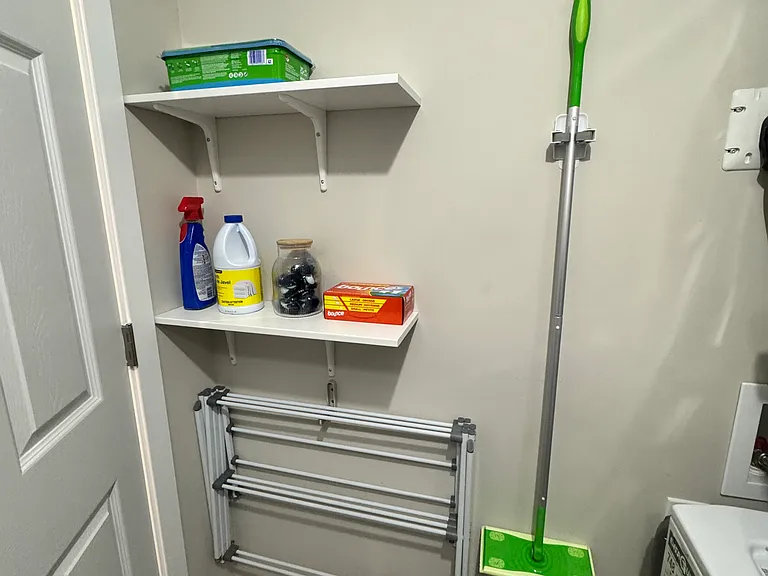 Stacked in-suite washer and dryer for private use in this furnished Ottawa suite.