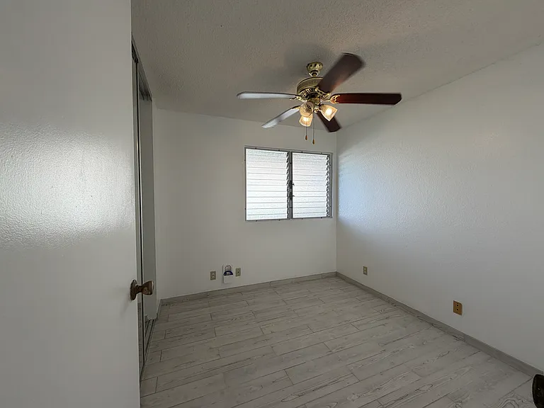 Bedroom 3, ceiling fan, floor to ceiling mirrored closet door, full sized closet.