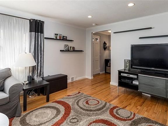 Refinished hardwood flooring, crown molding and recessed lighting make this family room a great space to enjoy with your family and friends.