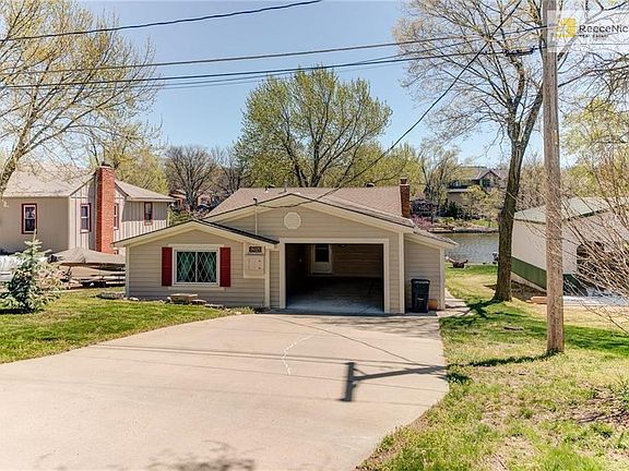 No garage door but full size garage with storage on the inside and a gardening shed on the side.