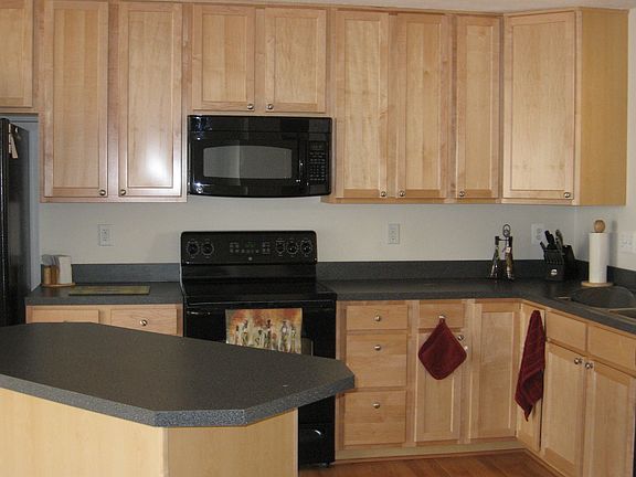 Country Kitchen with 42" Allwood Maple Cabinets & Matching GE Black Appliances