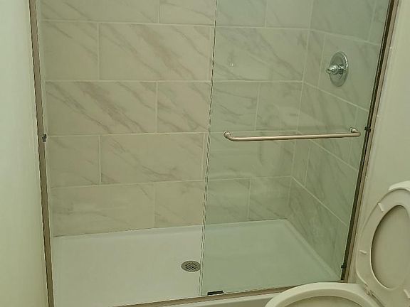 bathroom with granite countertop and ceramic flooring