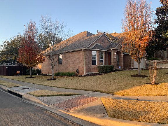 Side view of house, fantastic large and corner lot; view of side flower beds and entry into backyard