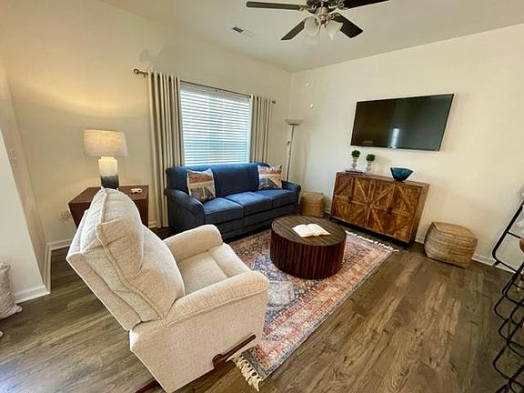 Living area has a large plush couch, Lazy Boy recliner and a 55" SMART TV