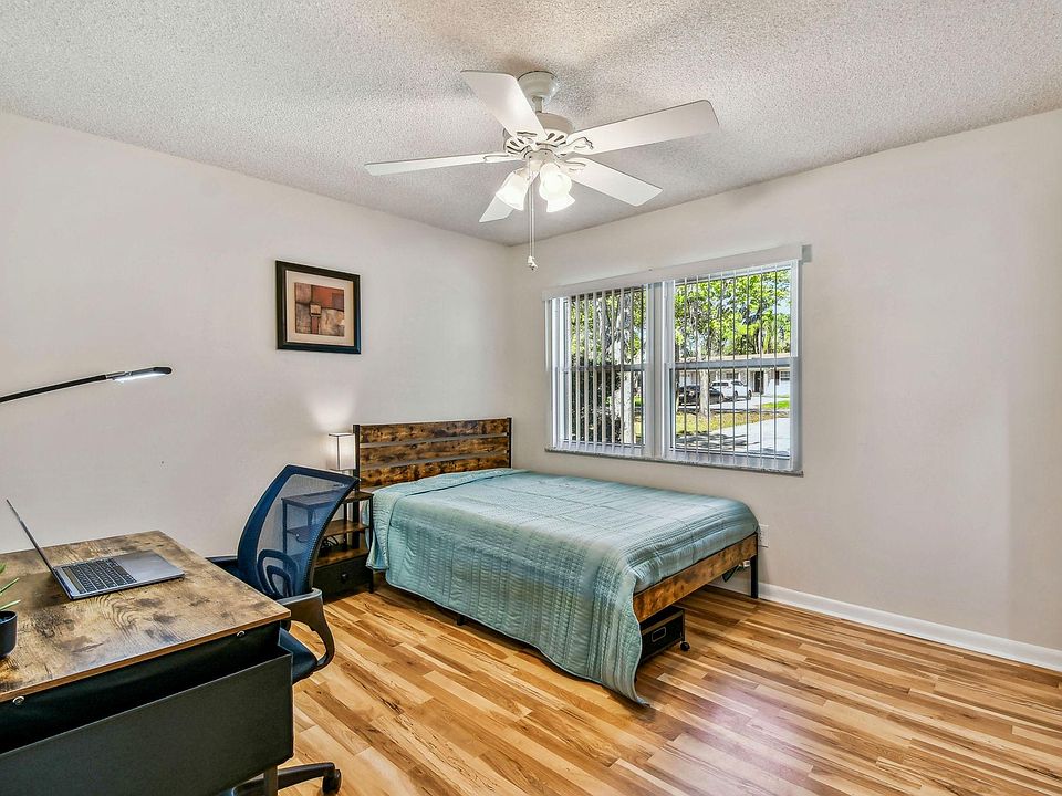 Full size cozy full size bed, with end table, light, desk, office chair and light, storage container under the bed and closet