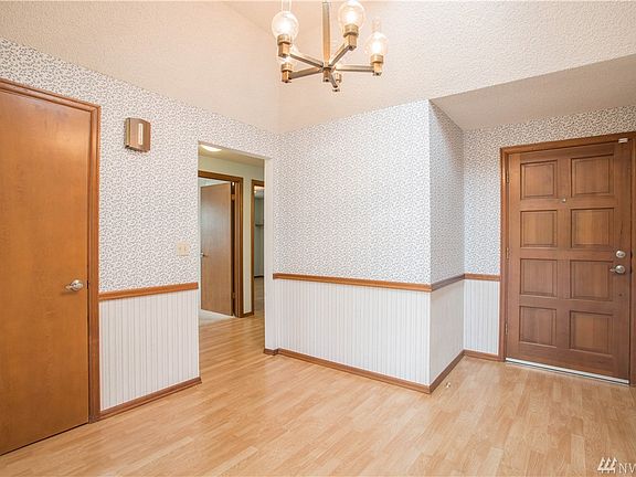 Massive entry with vaulted ceiling and skylights