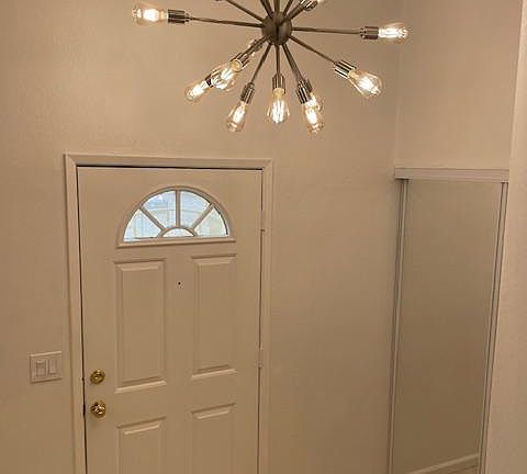 The well-lit entranceway has large, mirrored closets on each side.