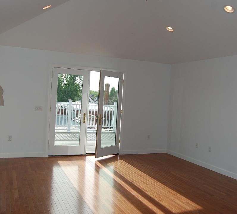 Extra-large living room with vaulted ceiling and French door