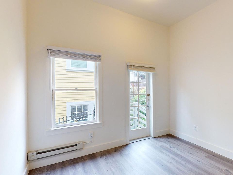 Living room with large windows and wood-like floors