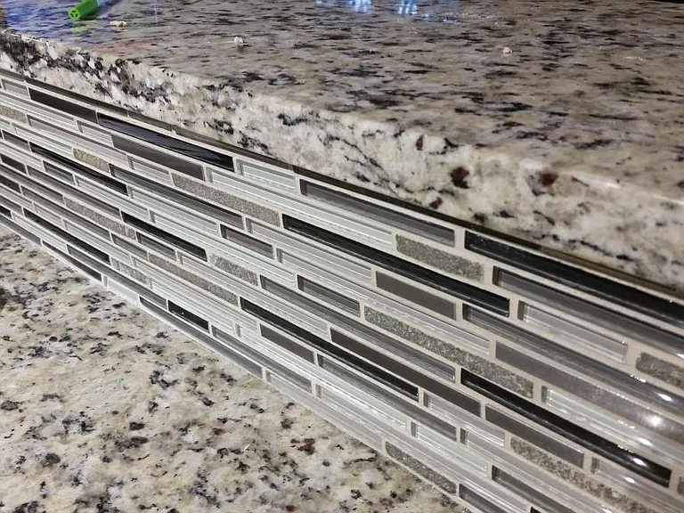 Granite and Glass Tile Backsplash