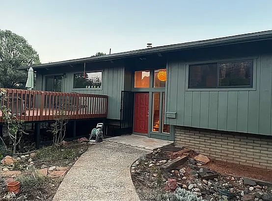 Private entry and front deck surrounded by nature