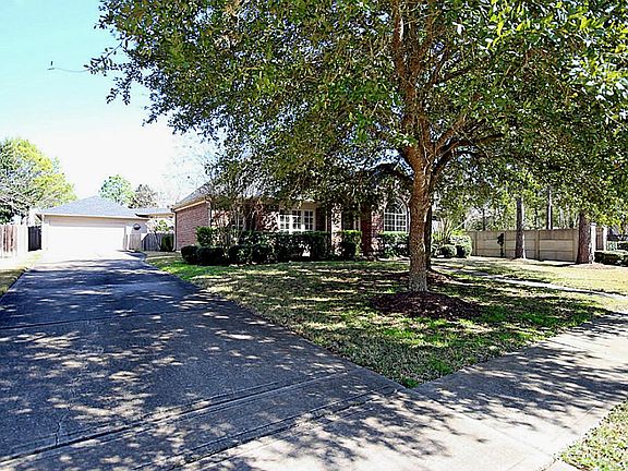 LONG DRIVE LEADS TO 2 CAR GARAGE THAT HAS EXTRA STORAGE AREA