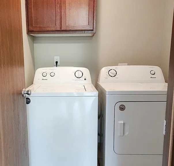 Convenient laundry area with included newer washer and dryer.