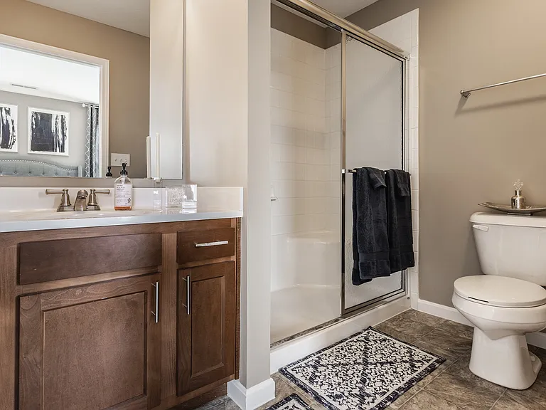 Step into a stylish bathroom at Wheaton Village, featuring a walk-in shower and a clean, inviting design for everyday comfort.