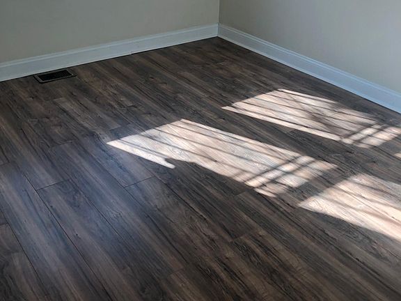 Showing newly installed floors. Beautiful walnut neutral color.