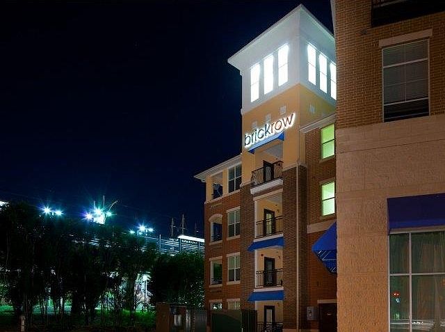 Beautifully lit exterior of Brick Row Apartments