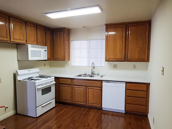 Large kitchen with upgraded stone countertop,stainless sink, dishwasher, microwave and stove.