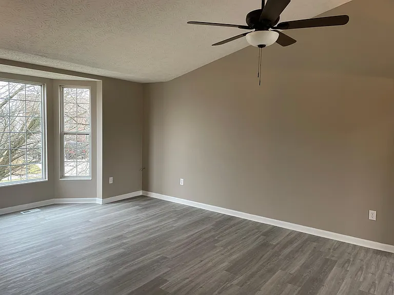 Great room has large bay window. New flooring, new paint and new light fixtures.