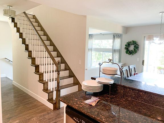 Two sliding doors out to the deck. One from dining room and one from living room. Beautiful filtered light with greenbelt and mature oaks out back.