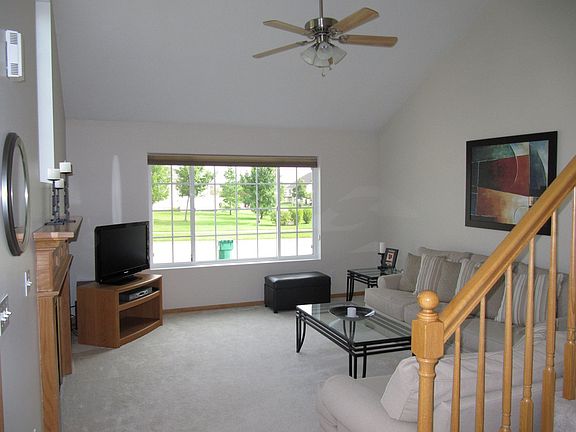 Family room on the main level with vaulted ceiling and gas fireplace