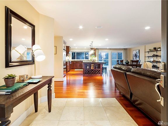Gleaming floors greet you as you enter the beautifully designed great room with updated kitchen, dining area, informal eating area and family room~Double sliders to deck overlooking your private yard and golf course