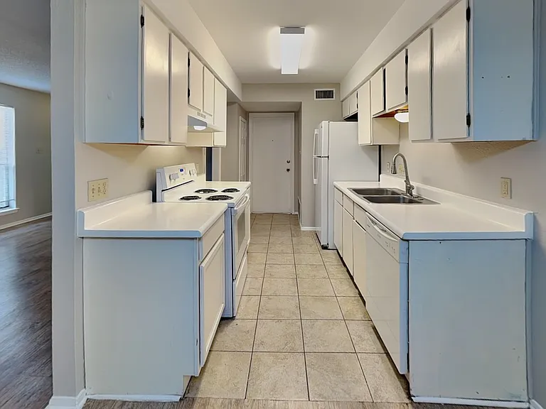 Spacious kitchen with white ca