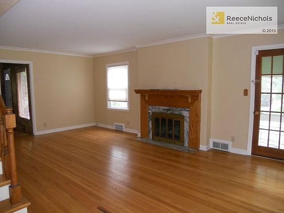 Living room as seen from the front entry.  Door on right leads t