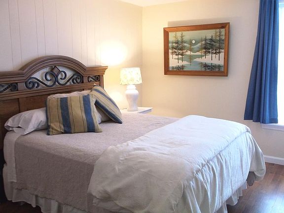 The spacious bedroom has a queen-sized bed.