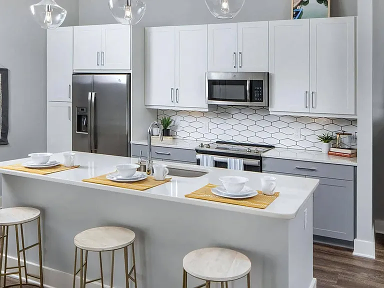 Fully-Equipped Kitchen with Stainless Steel Appliances and Quartz Island