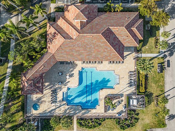 Cloubhouse outdoor deck include a hot tub, lap pool, grill area, and plenty of lounge seating