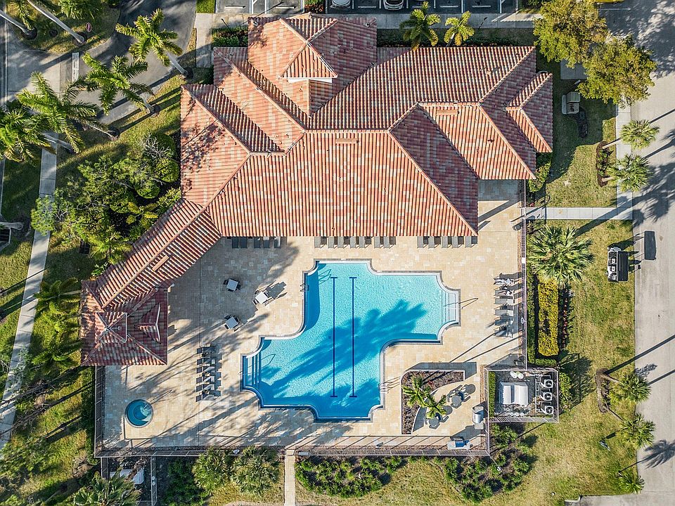 Cloubhouse outdoor deck include a hot tub, lap pool, grill area, and plenty of lounge seating