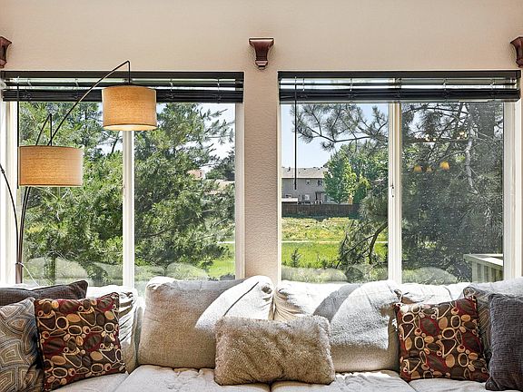 Bright and spacious living room with large windows and natural light.