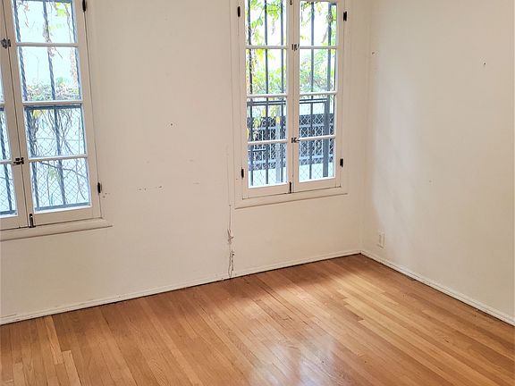 spacious bedroom with hardwood floors