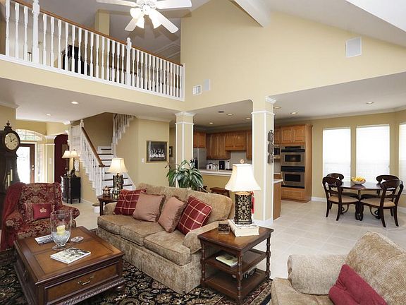Open concept offers lofty ceiling and wonderful flow from family room to breakfast area and kitchen.