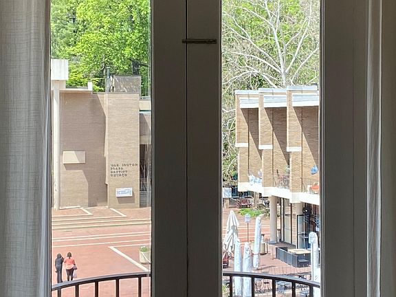 European living. Overlooking the plaza, Farmers market to the right around the corner or Saturday_s. Nail salon and Lake Ann coffee house and wine bar. Warm croissants and a coffee to go please!