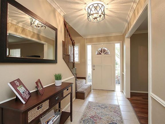 ENTRY - Spacious entry to greet your guests. Windows on either side of the front door let in natural light.