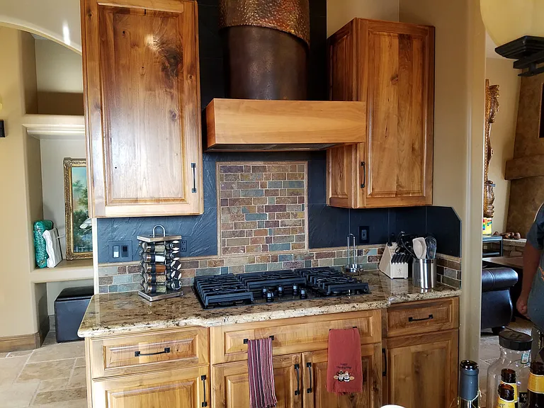kitchen stove with customer hood and cabinets
