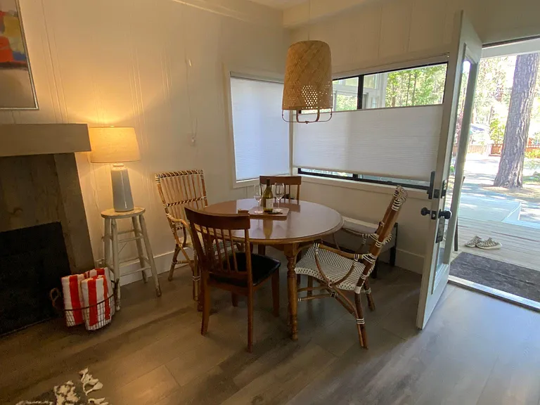 Dining table in living room with gas fireplace