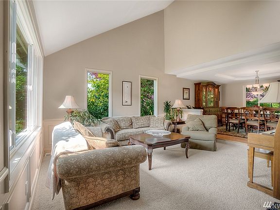 Lovely living room with windows overlooking the yard