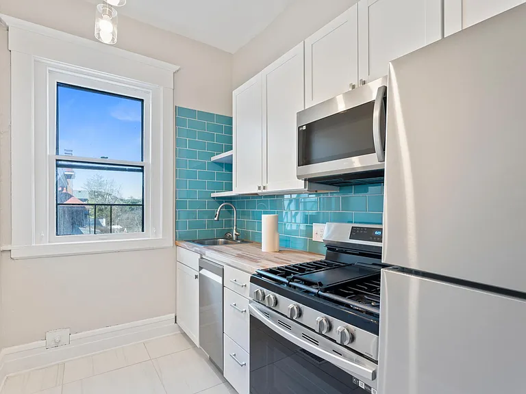 Kitchen. All appliances had to be located on one wall to accommodate access to fire escape through window.