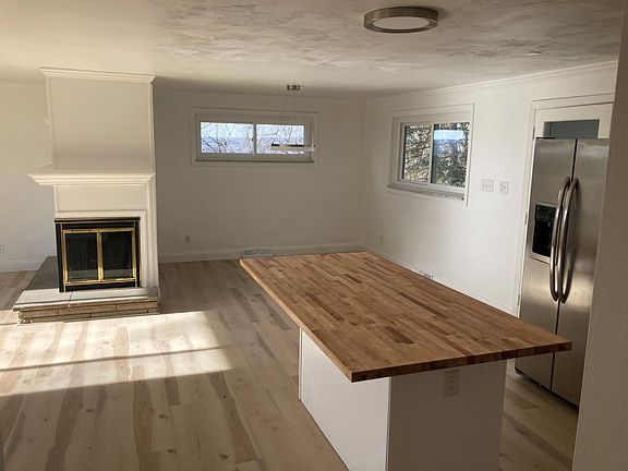 kitchen island looking into dining room and fireplace