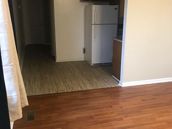 View from the door way in living room to the left looking down the hall past the kitchen. Bathroom is just past the kitchen.