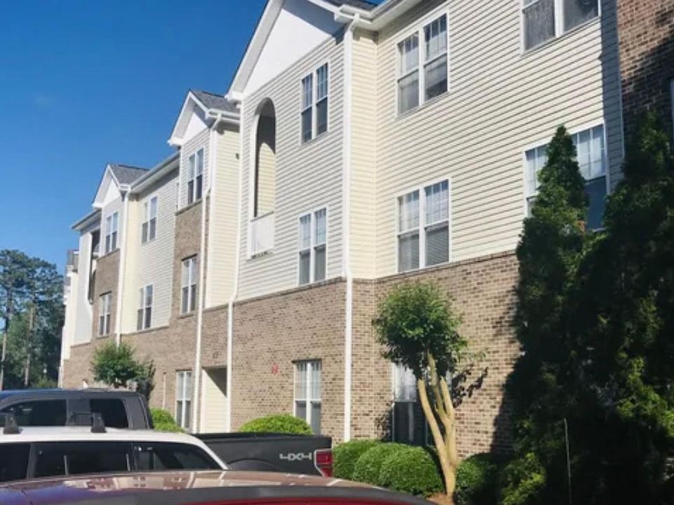 Exterior of building with two assigned parking spaces