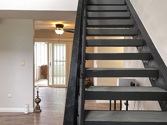 Staircase showing part of kitchen and patio